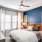 bedroom with large window, ceiling fan and lighting fixture