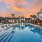 sparkling, fenced in swimming pool with cabanas