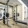 weight bench with weights in front of large mirror in fitness center