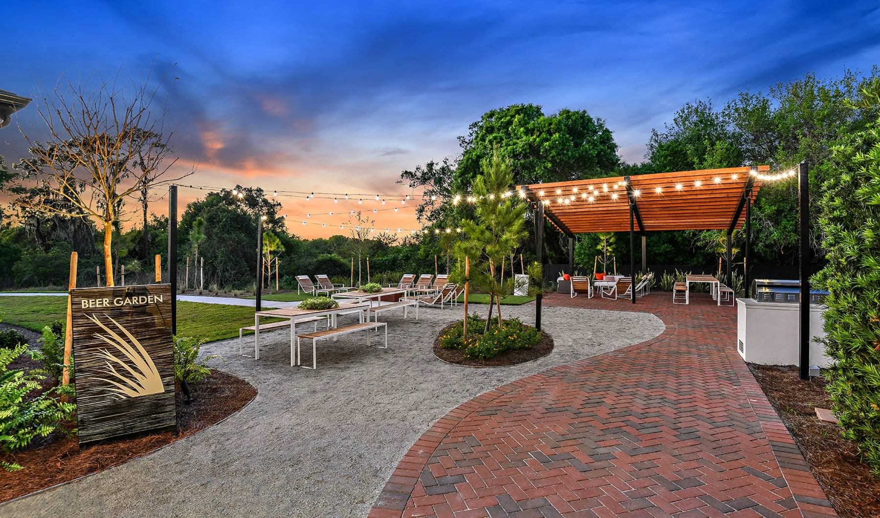 Enjoy A Lifestyle Like No Other large, beer garden with stringed lighting, pergola and grills